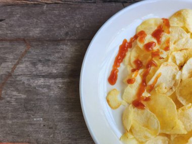 Tabakta patates cipsi ve ketçap var.