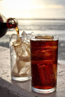 Buzlu bardağa kola dök.