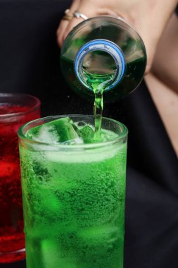 İçecekler ve buzlar kadehe dökülüyor.