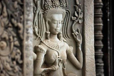 Woman dancing, carved into an ancient Khmer temple in Angkor Wat, Cambodia