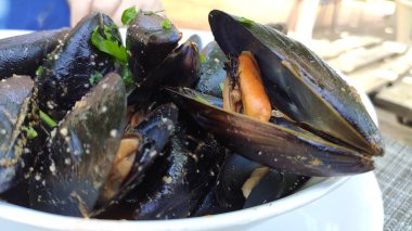 Delicious fresh steamed mussels in white wine sauce