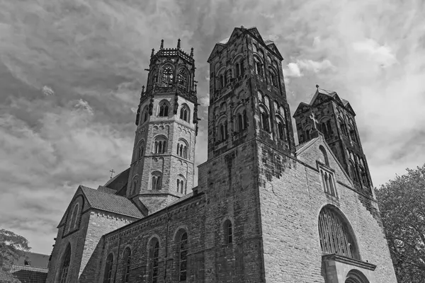 stock image St Ludgeri catholic church in Muenster, Germany against cloudy sky in black and white