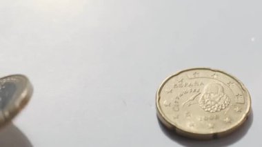 Düşen Altın Euro sikkeleri beyaz arka planda. Yavaş çekim