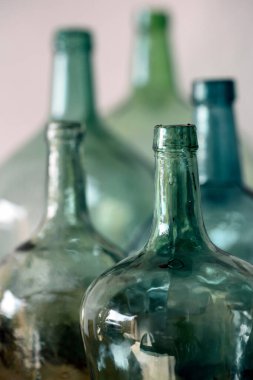 Beyaz arka planda yeşil cam sürahiler. Sığ odak derinliği