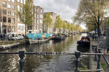 AMSTERDAM, NETHERLANDS - 9 Mayıs 2017: Oudekerksbrug Köprüsü Amsterdam 'da bulutlu bir bahar öğleden sonrasında