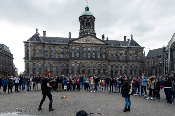 AMSTERDAM, NETHERLANDS - MAY 9, 2017: Street performers in front of the royal palace, in Dam square