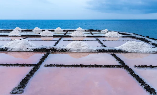 Pink color salt mines near the ocean in Fuencaliente