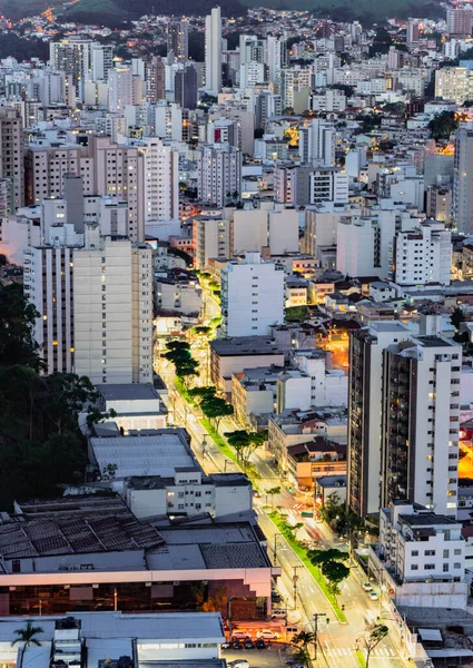 Experience the vibrant urban life of Juiz de Fora at night with this stunning long exposure shot of the city center. The towering skyscrapers and bustling traffic create a captivating contrast against