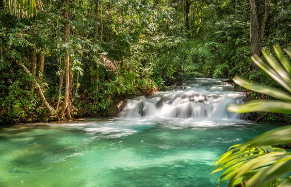Long exposure shot of Formiga Waterfall, also known as Ant Waterfall, with silky smooth crystal clear water and lush green surroundings. A serene and idyllic destination for tourists, with ample space
