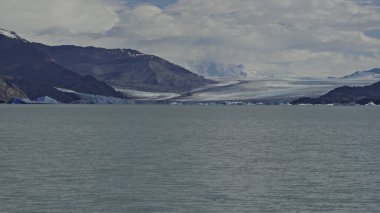 Boat tour on Lago Argentino showcasing the majestic Upsala Glacier, an emblem of natures splendor and environmental shifts. clipart