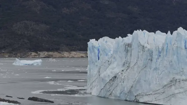 stock image Tourist boat approaches Perito Moreno Glaciers immense walls.