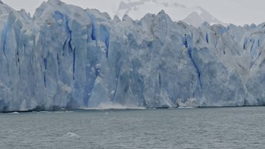 Stunning slow-mo video shows huge iceberg breaking from Perito Moreno Glacier into Argentine Lake. clipart