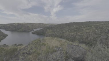 A panoramic view of the Duero River canyon and its Esla tributary in summer, with the camera panning left to right. clipart