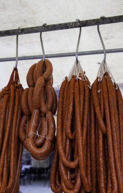 Detail of dried meat sausage in an old market, fatty food, pork