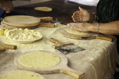 Detail of baker kneading and working the dough to make bread