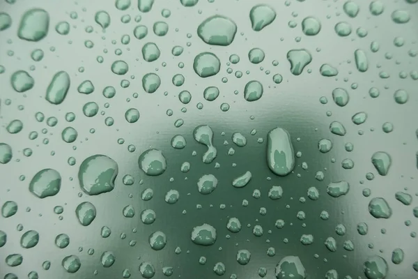 Detail of raindrops on a metallic background, cold and winter