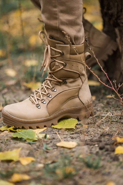 Leather waterproof boots on military. Demi-season high boots of khaki color