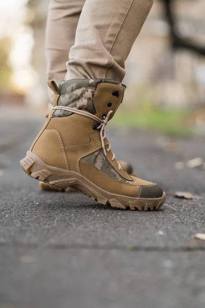 Leather waterproof boots on military. Demi-season high boots of khaki color  - Stock Image - Everypixel