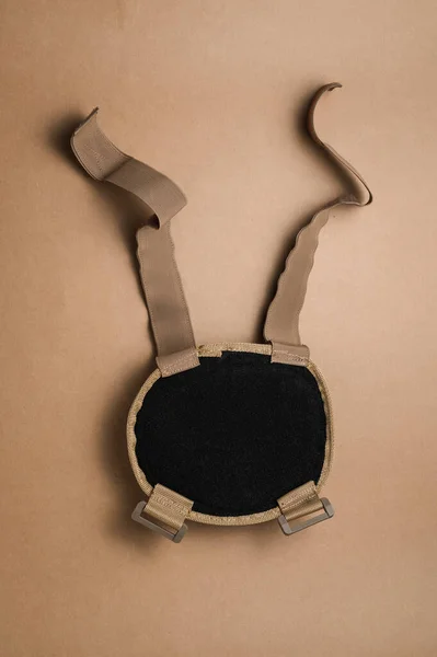 Protective knee pads for soldiers on a beige background