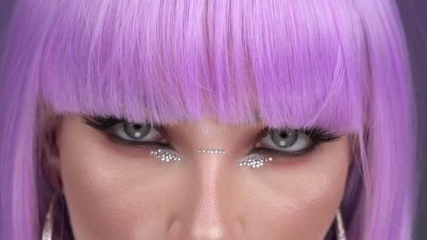 一个穿着紫色假发的奢侈品模特出现在演播室里 紫色背景 30Fps — 图库视频影像