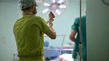 Cerrahlar, karmaşık bir cerrahi müdahale için kendilerini titizlikle bir ameliyathanede hazırlıyorlar.