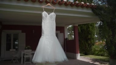 Wedding dress hanging on the house. High quality 4k footage
