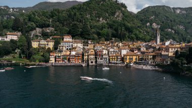 Aerial view of boat trip near Bellano, panoramic view from the drone to the famous old Italy town of Como lake. Near Varenna and Lierna, Bellano is a small town in Como, near Lecco, in Lombardia. clipart