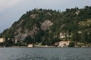 A stunning view of Lecco, a picturesque town located on the southeastern shore of Lake Como, framed by the dramatic peaks of the Grigna Mountains. clipart