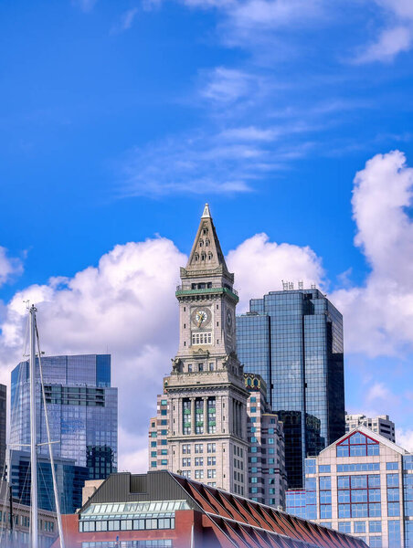 The Custom House Tower along the Boston, Massachusetts skyline on a sunny day.