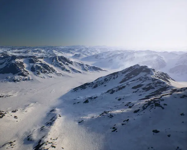 Arctic landscape with snow mountains under a clear blue sky.