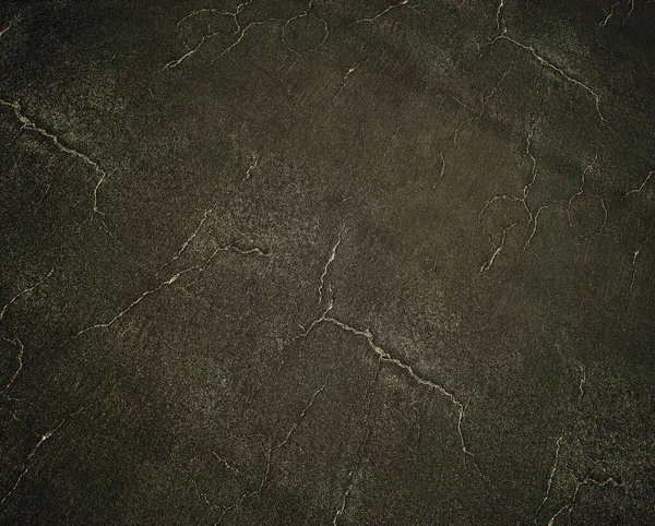 Worn out and cracked old asphalt. Detail shot.