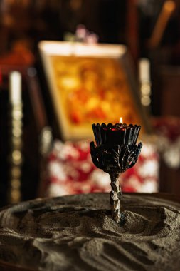 Mum ve mum eski bir anıt şapelinde bir kase kumun üzerinde..