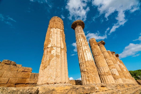 Explore the majestic ancient Greek ruins in Sicily, showcasing stunning architecture against a clear blue sky.