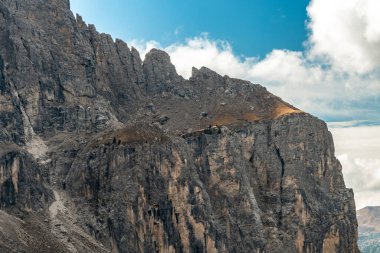 Experience the stunning beauty of the Alps in Italy, showcasing magnificent rocky peaks and vibrant greenery under a dramatic sky. clipart