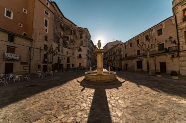 Explore a timeless Spanish square featuring a fountain, cobblestone streets, and charming architecture. Perfect for travel themes. clipart