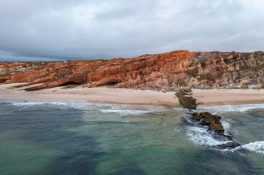 Breathtaking aerial shot of Portugals coastline, showcasing dramatic cliffs, sandy beaches, and turquoise waters. clipart