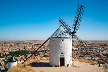 Don Kişot hikayelerinin bir sembolü olan Consuegra 'nın tarihi yel değirmenlerinin yer aldığı büyüleyici yaz manzarasını keşfedin..