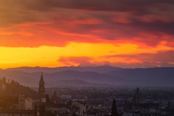 The city of Florence and the Apennines seen from above at the sunset