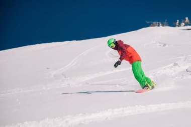 Karpaty, Ukraine, February 8, 2023. Skiers and snowboarders freeride in clear sunny weather on the slopes of the mountains near the resort of Dragobrat. High quality photo