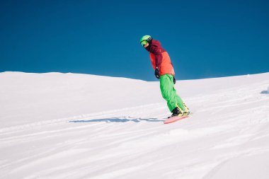 Karpaty, Ukraine, February 8, 2023. Skiers and snowboarders freeride in clear sunny weather on the slopes of the mountains near the resort of Dragobrat. High quality photo