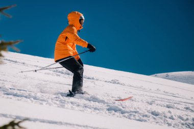 Karpaty, Ukraine, February 8, 2023. Skiers and snowboarders freeride in clear sunny weather on the slopes of the mountains near the resort of Dragobrat. High quality photo