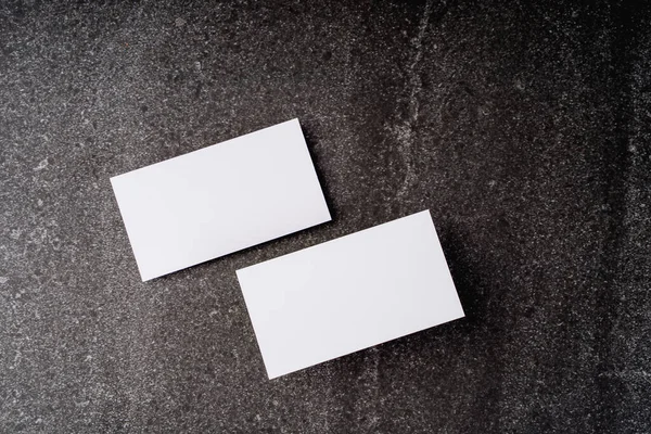 Business card mockup, front and back, on a dark background, a template for design presentation, thick cardboard visiting cards floating on black