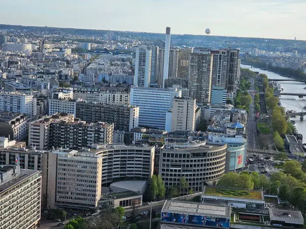 stock image Paris, France - April 12, 2024: Aerial view of Paris skyline with dense urban sprawl and modern skyscrapers, Ile de France, France.  Amazing mix between modern skyscraoers and old buildings.