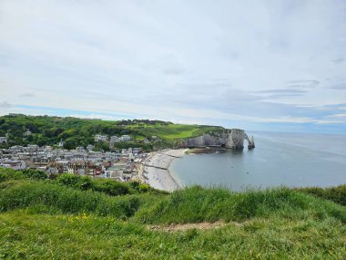 Normandiya, Fransa - 18 Mayıs 2024: Etretat uçurumlarındaki resimli panoramik manzara. Doğal muhteşem uçurumlar. Etretat, Normandiya, Fransa, La Manche veya Manş Denizi. Güneşli yaz gününde Pays de Caux bölgesinin kıyısında. Fransa