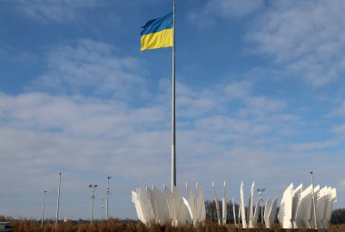 Geographical center of Ukraine. Waving flag of Ukraine on a high flagpole.