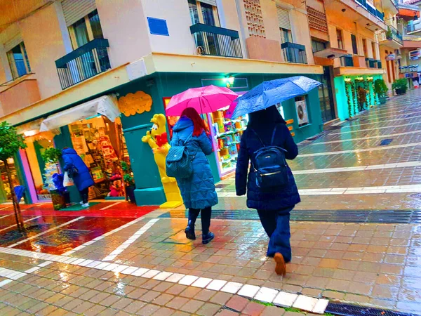 rain umbrellas in city downtown market xmas morning in  ioannina greece