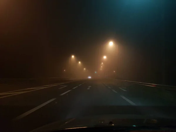 road cars in fog foggy night lights in egnatia stree greece, ioannina region