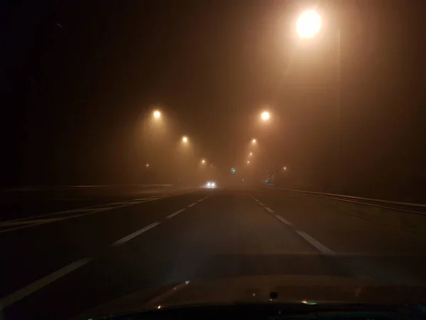 road cars in fog foggy night lights in egnatia stree greece, ioannina region