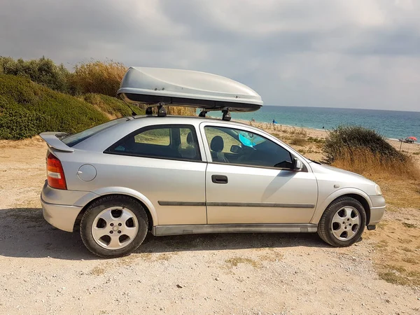 roof rack of car parked by the sea in the summer holidays