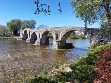 arta arched bridge in arahthos river greece in spring season